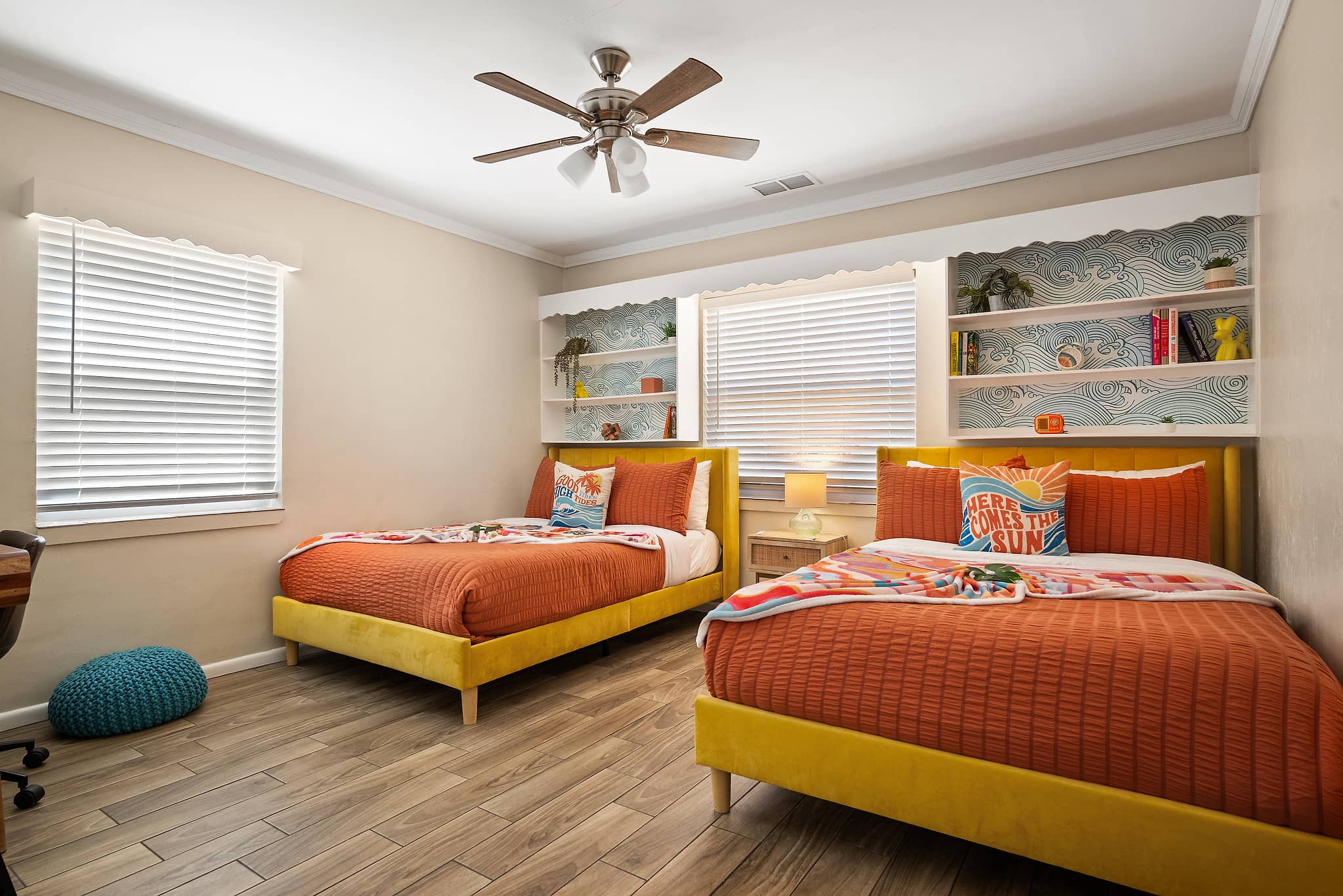 Two full beds with yellow frames and ocean wave wallpaper in the Sunshine Retreat room at Tropical Disco vacation rental St. Petersburg Florida